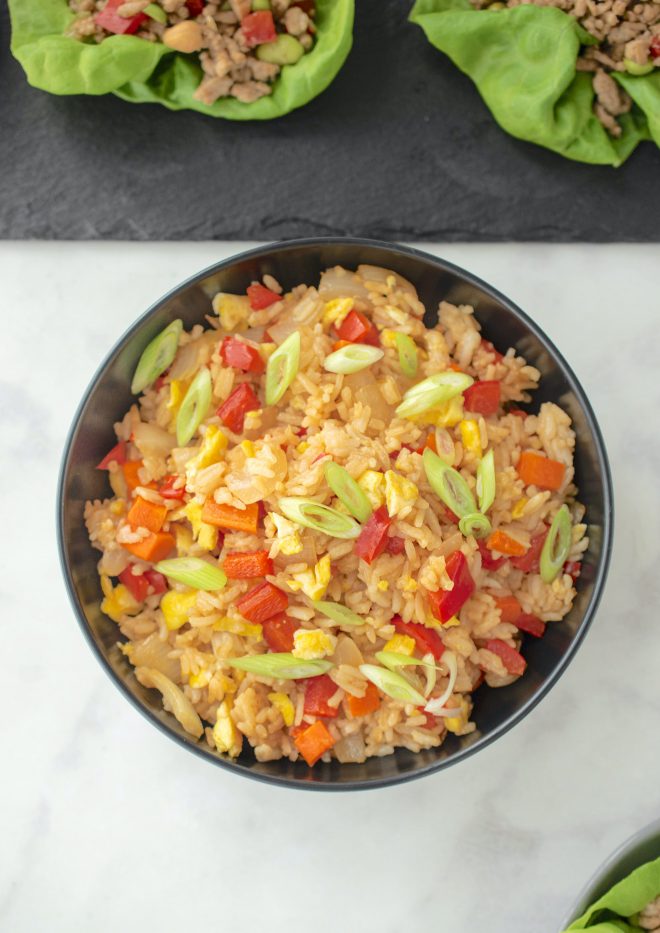 A bowl of colorful vegetable fried rice from above