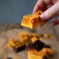 Holding a piece of 3 Ingredient Cinder Honeycomb Toffee