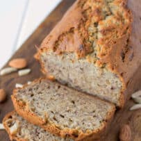 A loaf of banana bread with 2 slices