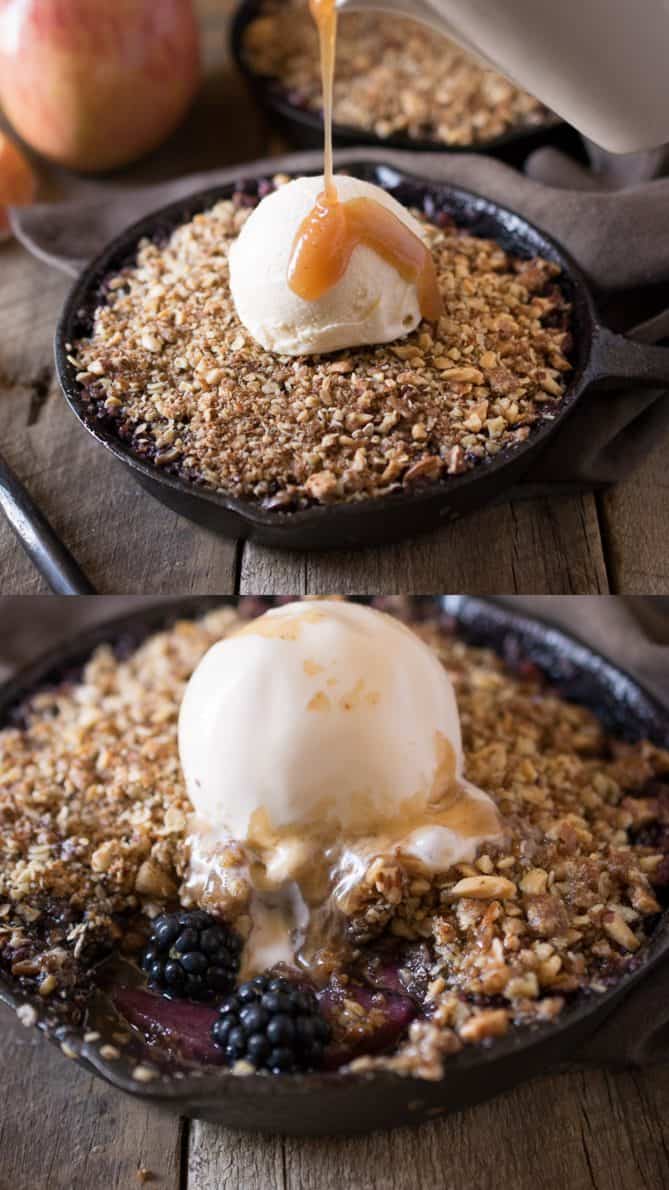 Drizzling caramel over vanilla ice cream that is on top of apple and blackberry crumble
