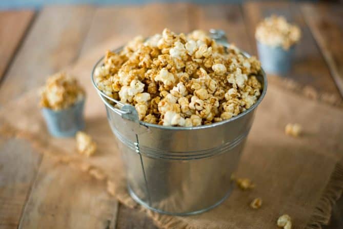 A silver bucket of of apple cider caramel popcorn
