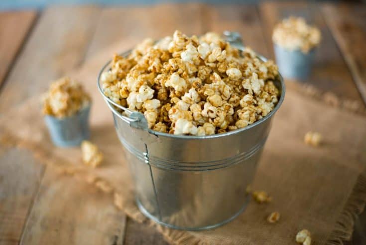 A silver bucket of of apple cider caramel popcorn
