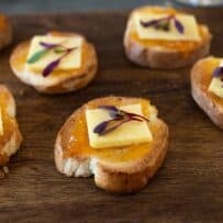 Toasted baguette slices topped with apricot preserves and white cheddar