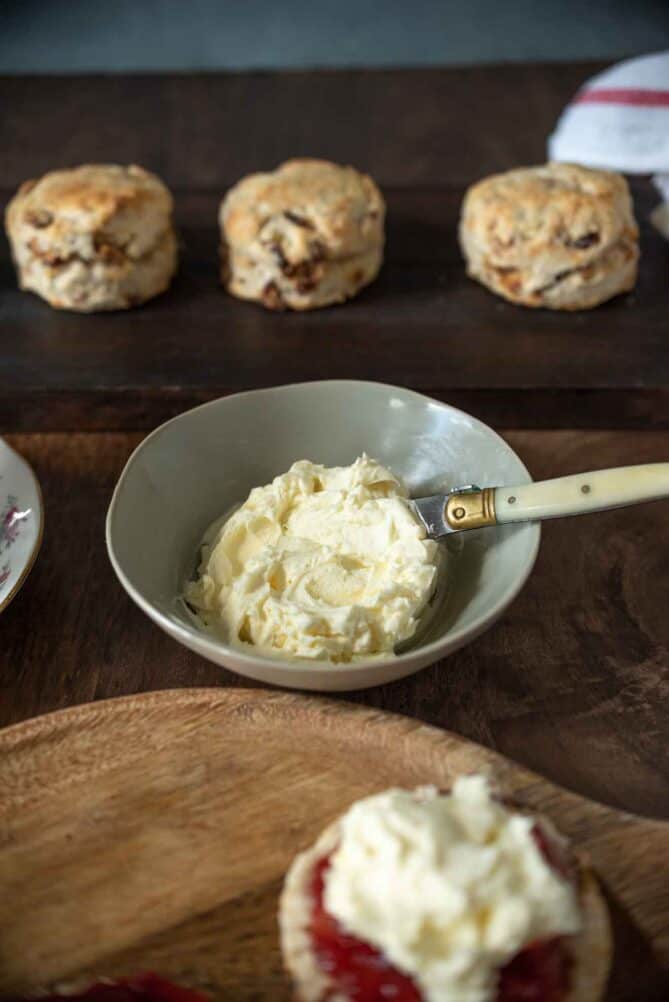 Clotted cream in a bowl with a knife