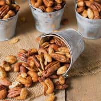 Almonds, pecans, cashews and pumpkin seeds spilled out onto a mat