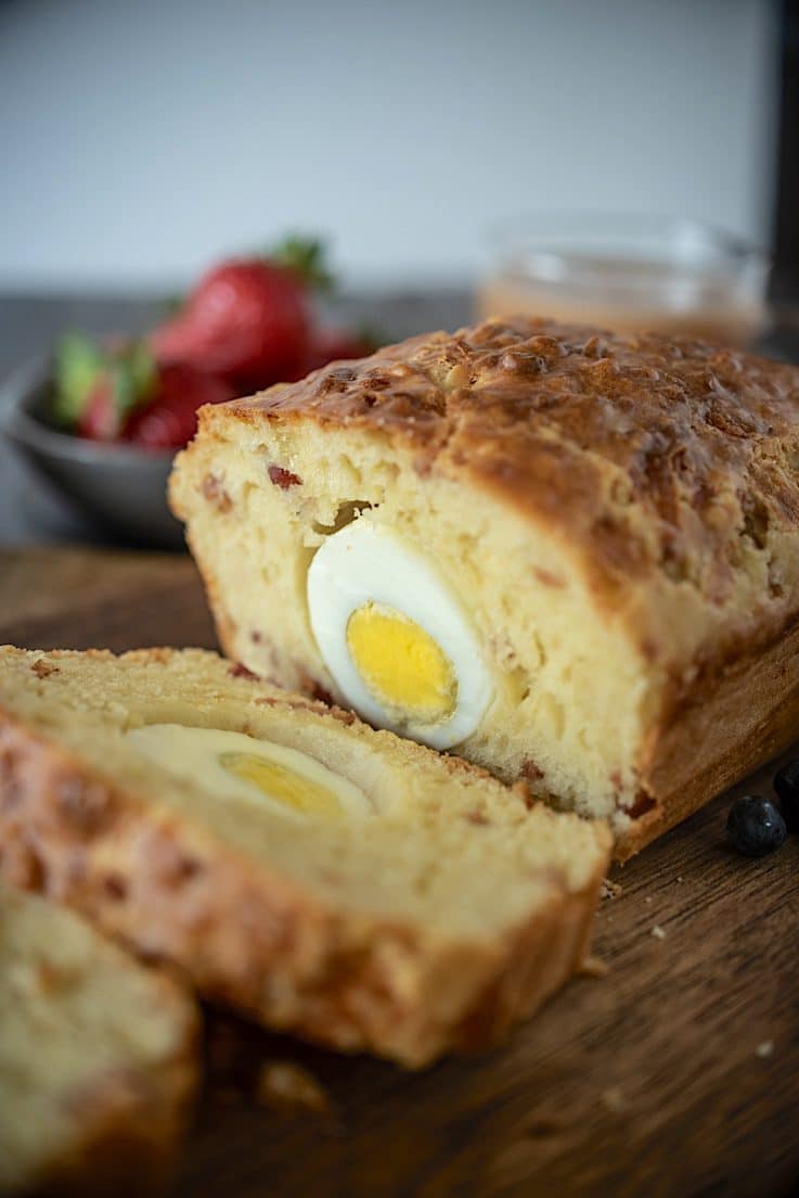 A closeup of the sliced loaf showing the bacon bits and hard boiled egg