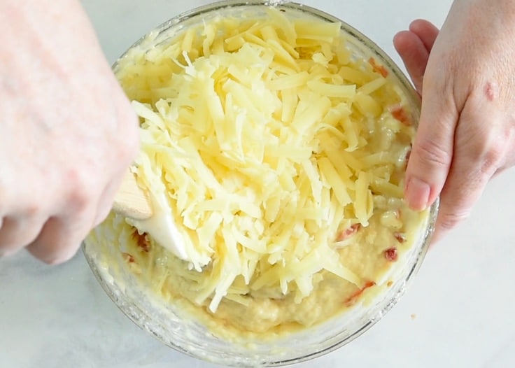 Grated cheese being stirred into them mix