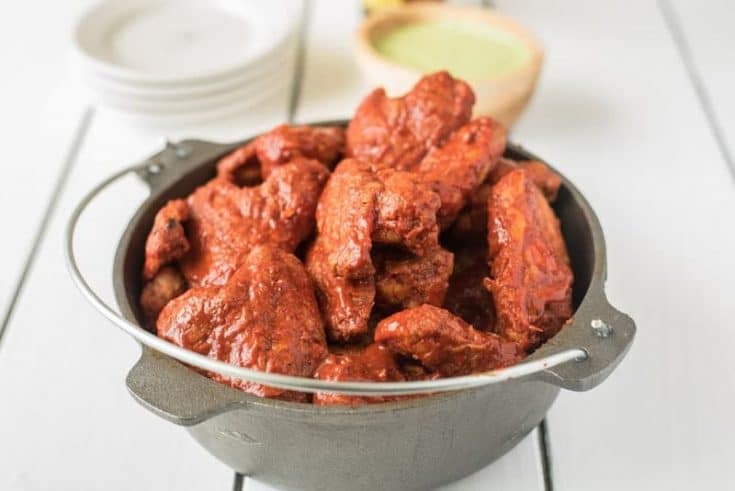 Baked adobo chicken wings bring a Mexican twist to a favorite finger food. Wings are baked to crispy perfection then bathed in a delicious adobo sauce made with dried peppers and spices. Grab the napkins...