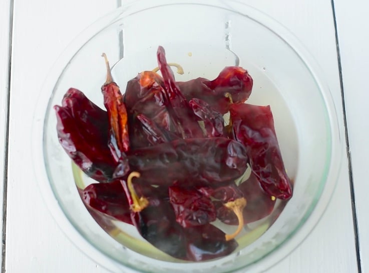 Guajillo peppers are softened in boiling water