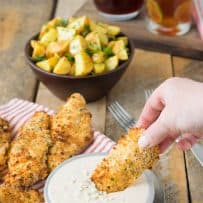 Dipping a baked chicken tender into buffalo blue cheese sauce