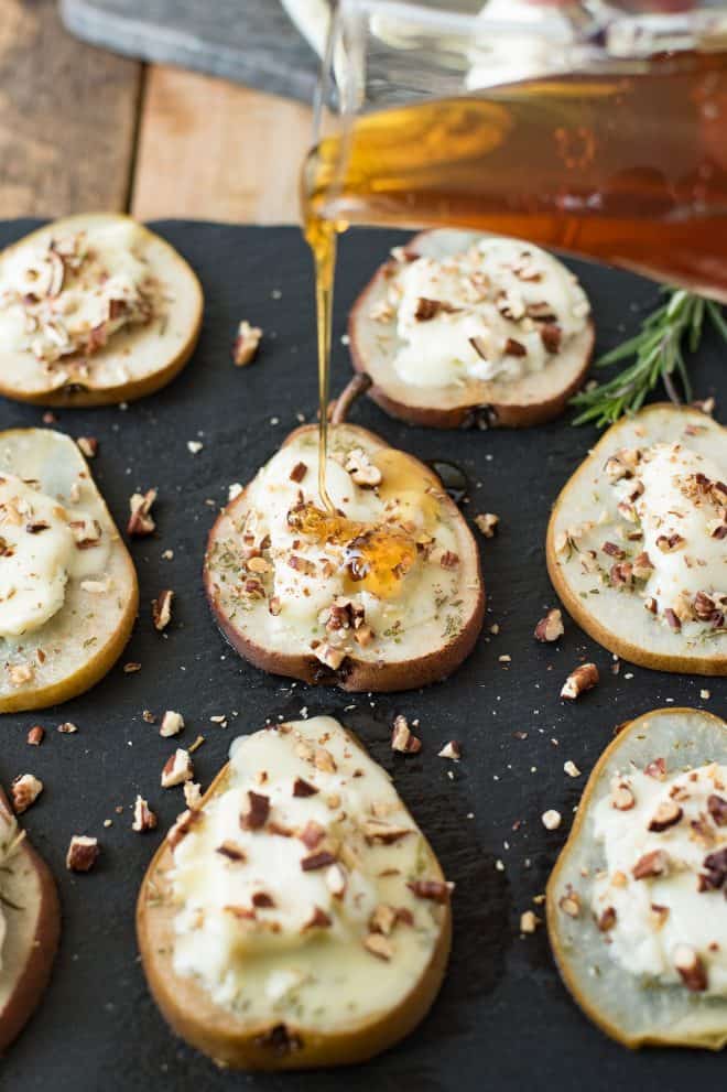 Drizzling honey over baked pears with goat cheese and pecans