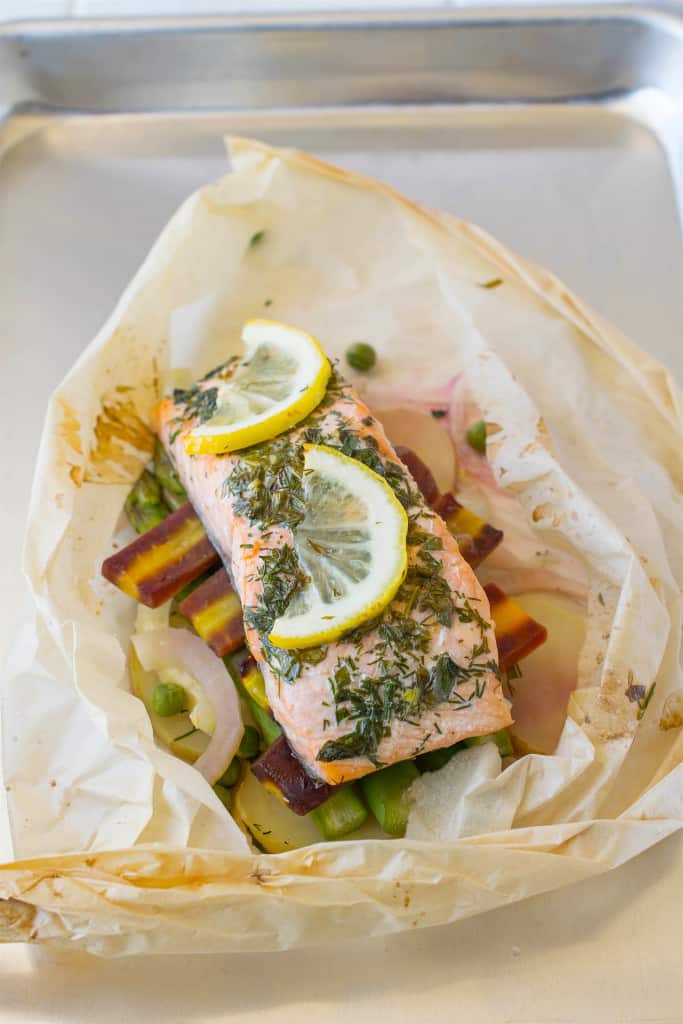 The salmon and vegetable out of the oven being unwrapped