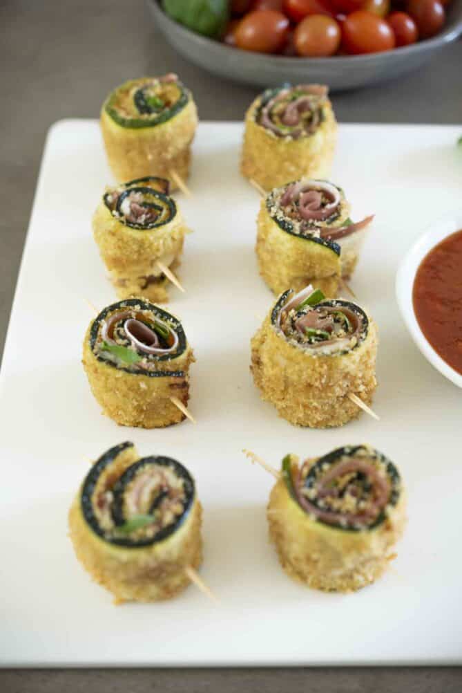 8 zucchini roll-ups on a white platter