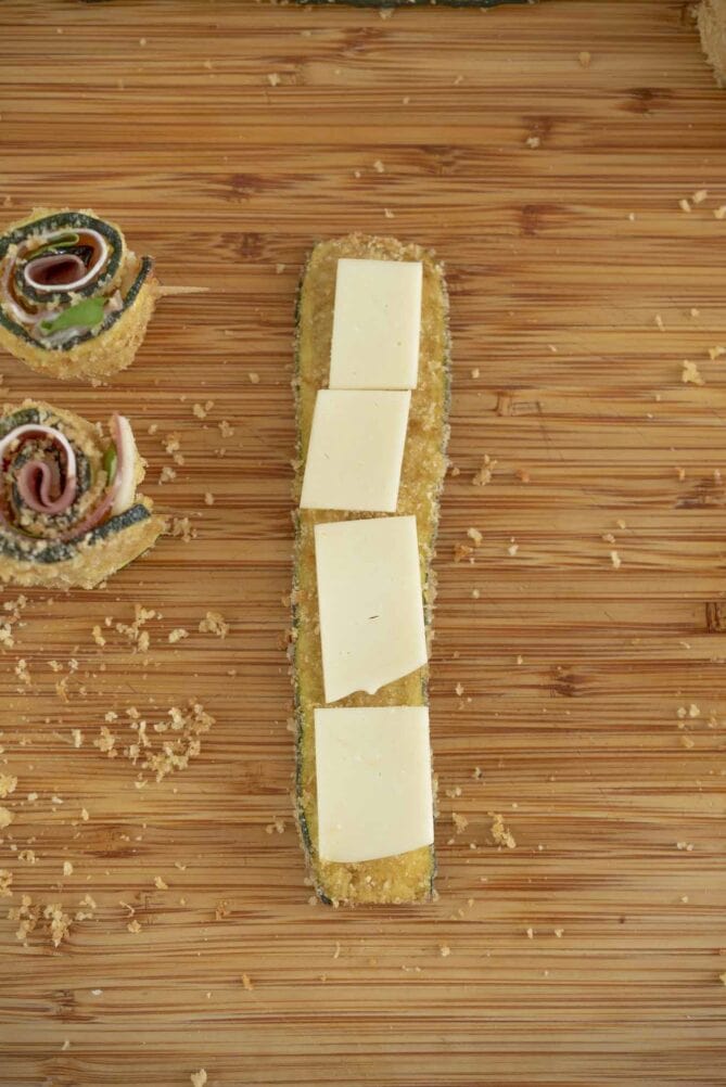 Pieces of cheese on a baked zucchini strip