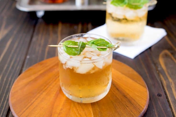 A glass of basil julep on a board