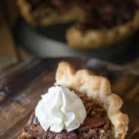 A slice of Bourbon Pecan Pie on a serving board