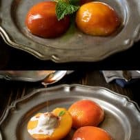 Poached peach halves on a plate with ice cream garnished with fresh mint
