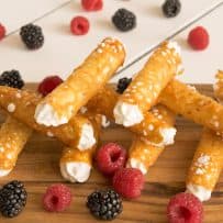 Brandy Snaps stacked on one another with berries