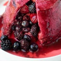 A closeup of the berries inside a bread dome with the berry juices