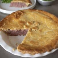 British Corned Beef and Potato Pie with a slice removed