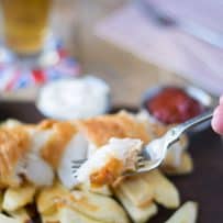 Flaky fried fish on a fork