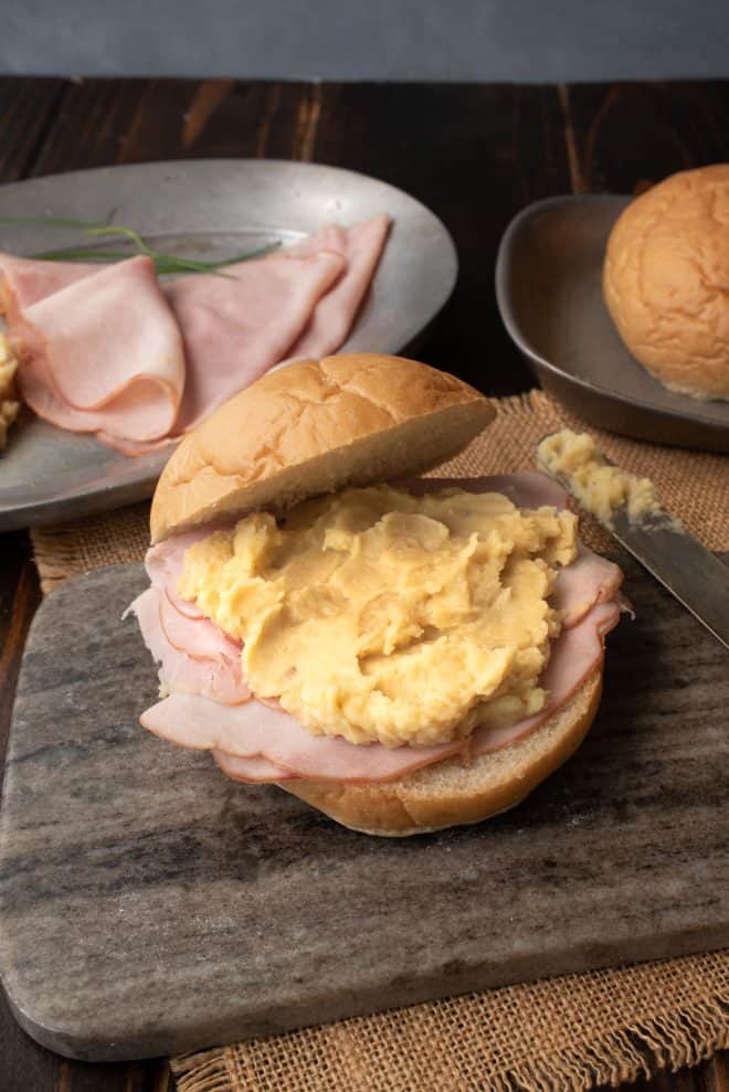 Pease pudding served with ham on a bread roll