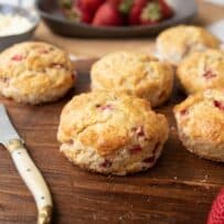 6 strawberry scones on a board with a butter knife