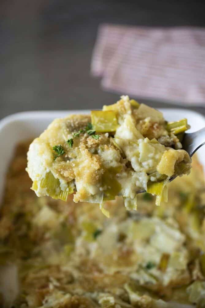 A large spoonful of leeks in a cheese sauce