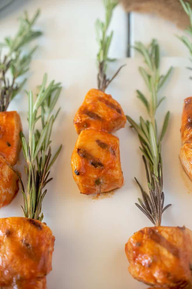 A closeup showing the buffalo chicken grill marks and fresh rosemary sprigs