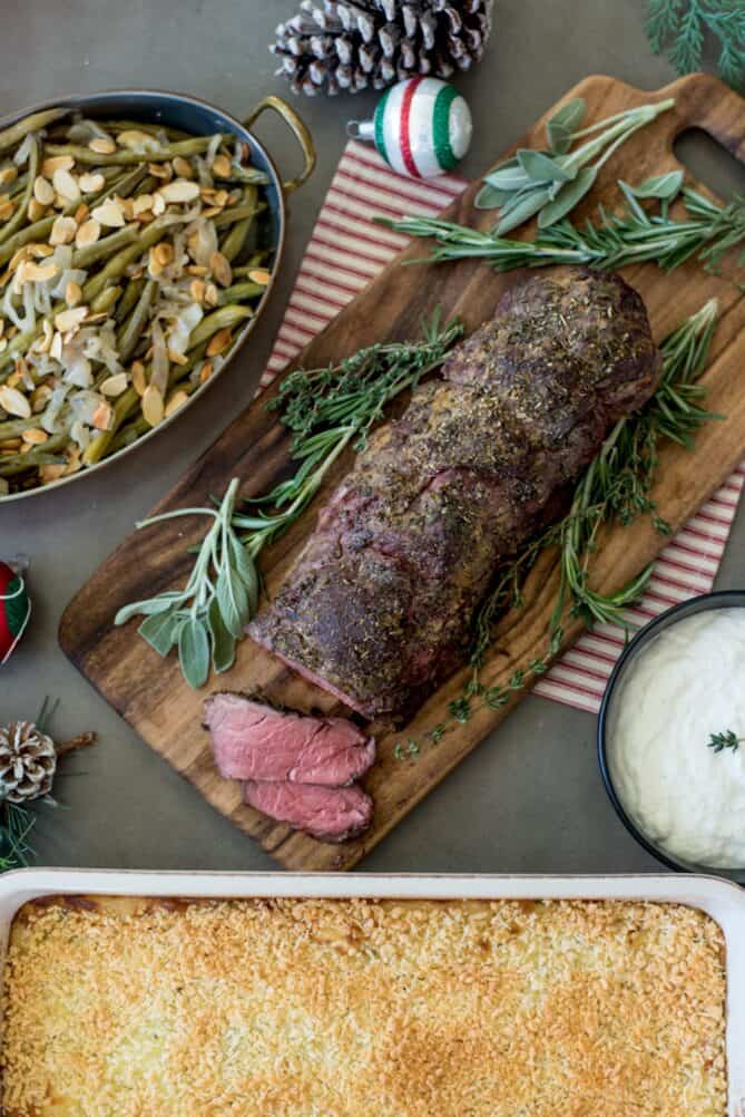 A beef tenderloin on a cutting board