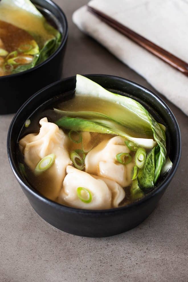 Chicken wontons in broth with bok choy and spring onions