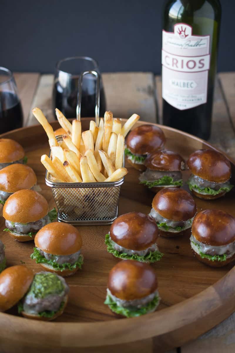 Chimichurri burger bites on a board with French fries
