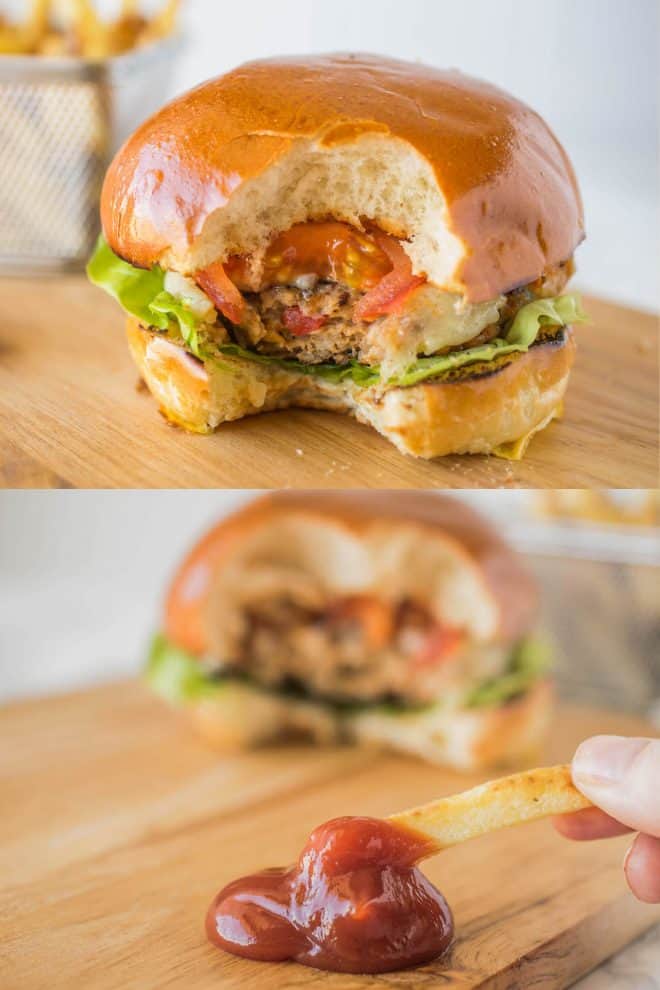 Chipotle chicken burger with a bite taken and dipping a French fry into ketchup