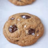 Large flakes of sea salt on top of a chocolate chunk cookie