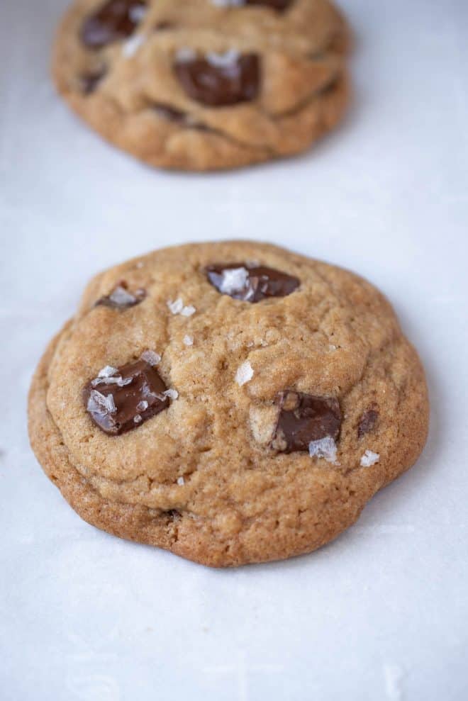 Large flakes of sea salt on top of a chocolate chunk cookie