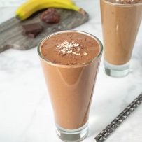 2 glasses of chocolate smoothie with straws