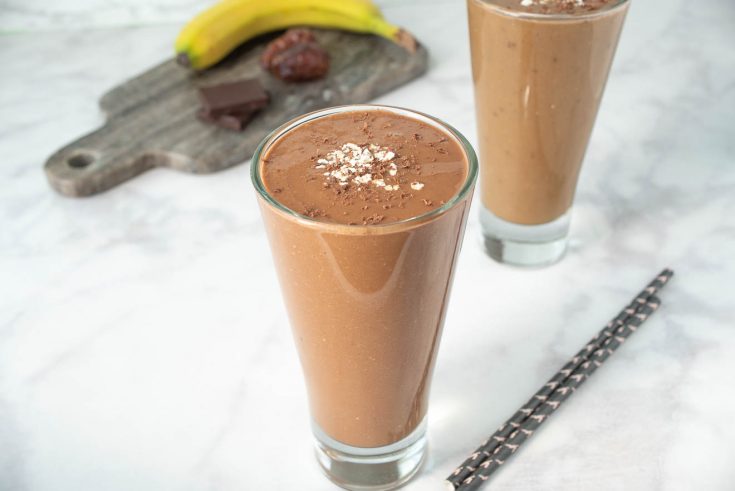 2 glasses of chocolate smoothie with straws