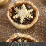 Sweet mince pies on a board dusted with powdered sugar