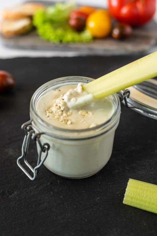 Dipping celery into blue cheese dressing