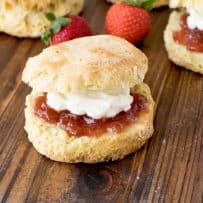 A Classic British Scone topped with strawberry jam and clotted cream