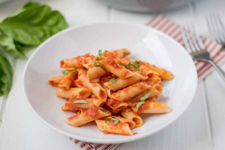 A white bowl filled with penne all'arrabbiata