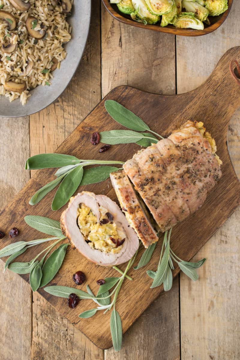 Sliced stuffed pork loin showing the cornbread apple and cranberry stuffing