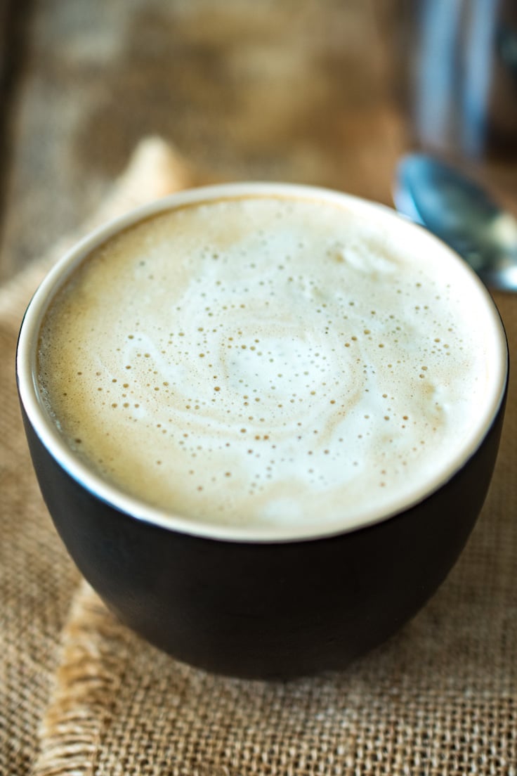 This creamy almond coconut cashew coffee will be your new chilly morning wake-me-up drink that is dairy free. Healthy almond milk is blended and thickened with coconut oil, cashews and a little honey for a creamy coffee creamer. This is Bulletproof coffee meets healthy latte.