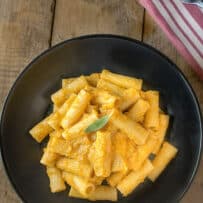A black bowl filled with butternut squash pasta