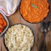 2 bowls of mashed potato, one with regular potatoes and one with yams/sweet potato