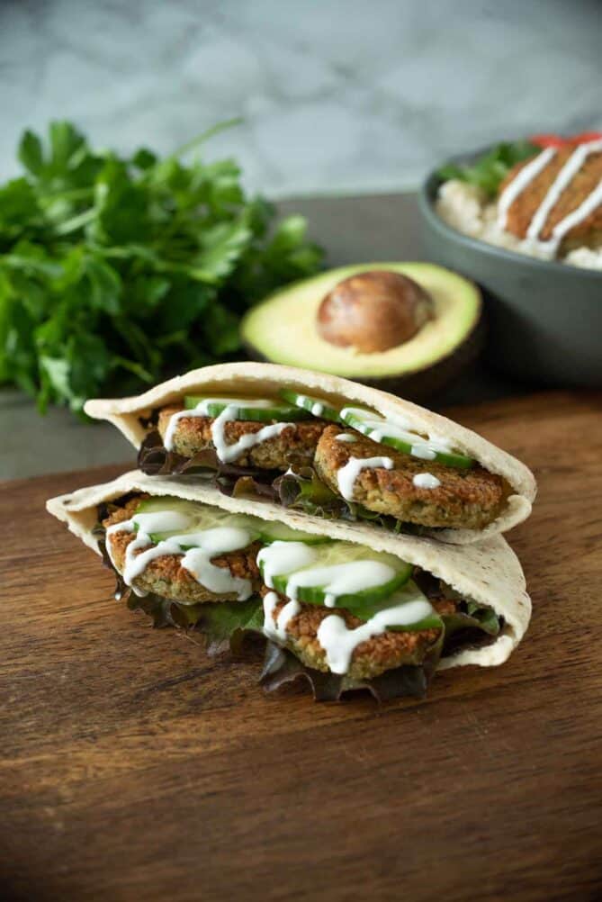 Falafel in a pita pocket with cucumber slices and lettuce