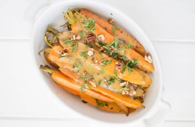 Crockpot orange, honey and herb glazed carrots are a stunning side dish that will be a stunning addition to your holiday or Sunday dinner table.
