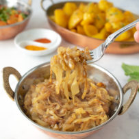 A fork full of curry caramelized onions