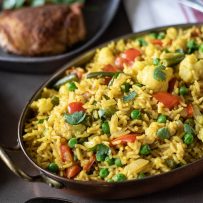 An oval serving dish of the rice served with chicken