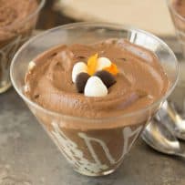 A closeup of a bowl of dark chocolate espresso mousse with 3 spoons